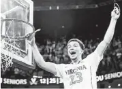  ?? Steve Helber / Associated Press ?? Virginia’s London Perrantes was all smiles after the Cavaliers wrapped up the ACC regular-season title.