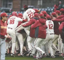  ?? Special to The Sentinel-Record/Craven Whitlow ?? WALK-OFF WINNER: The Arkansas Razorbacks celebrate after a walk-off single by sophomore center fielder Dominic Fletcher in the bottom of the eighth inning Sunday to beat the USC Trojans, 7-6, and win the rubber match of the three-game series.