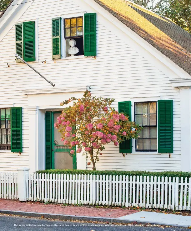  ??  ?? The owner added salvaged green shutters and screen doors as well as old panes of wavy glass to his ca. 1820 cottage in Provinceto­wn.