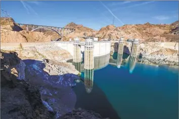  ?? Allen J. Schaben Los Angeles Times ?? HOOVER DAM’S promise of abundant water took the brakes off the growth of Western cities. It encouraged farmers to plant thirsty crops and gave city dwellers the impression they could water their lawns every day.