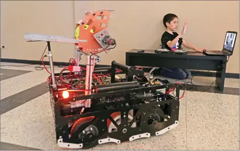  ?? REUTERS ?? A child uses his hand to move a robot during a high school technology fair in Santiago, Chile on Wednesday.