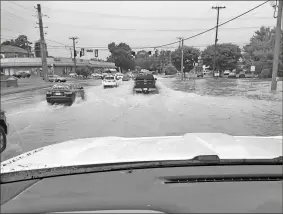  ?? Wes Roland ?? Ida’s affects finally made it to Northwest Georgia Monday evening in the form of heavy rain and storms. Red Bud Road near Highway 41 was one of the areas where water made it over the roadway.