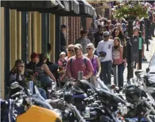  ?? GETTY IMAGES ?? DEDICATED SOULS: People walk through Deadwood, S.D., during the 80th annual Sturgis Motorcycle Rally Sunday. While it usually attracts around 500,000 people, officials estimate more than 250,000 may still show up despite the pandemic.