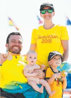 ?? Picture: GETTY IMAGES ?? GOLDEN AGE: Marathon gold medallist Kurt Fearnley with wife Sheridan, son Harry and daughter Emilia at the Gold Coast Commonweal­th Games.