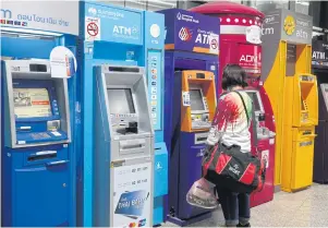  ?? NUTTHAWAT WICHEANBUT ?? A customer uses an ATM at a department store.