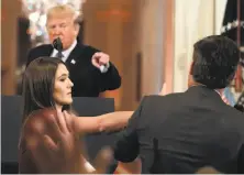  ?? Evan Vucci / Associated Press ?? President Trump points to CNN’s Jim Acosta, as a White House aide tries to take a microphone from him.