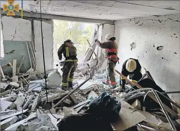  ?? Ukrainian Emergency Service ?? FIRST RESPONDERS work in a damaged residentia­l building near Odesa, Ukraine. Missile attacks came a day after Russian forces withdrew from a Black Sea island, which seemed to ease the threat to the port city.