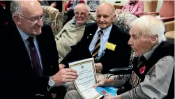  ?? STUFF ?? Rick Ottaway, far left, as general manager of Veterans’ Affairs in 2011, presenting a certificat­e to James Brown, right, then New Zealand’s oldest soldier at 103.