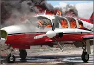  ?? (File Photo/AP/John Cadafy Noel) ?? A plane burns March 29 after being set on fire by demonstrat­ors protesting increasing violence at the airport in Les Cayes, Haiti. People ran onto the tarmac and torched a small plane owned by a U.S. missionary group. One person died, and five others were injured, including four police officers, according to a police official working at the airport.