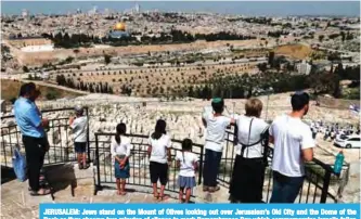  ?? —AFP ?? JERUSALEM: Jews stand on the Mount of Olives looking out over Jerusalem’s Old City and the Dome of the Rock as they observe two minutes of silence to mark Remembranc­e Day which commemorat­es Israel’s fallen soldiers yesterday.