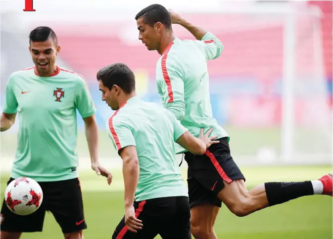  ??  ?? KAZAN: Portugal’s forward Cristiano Ronaldo (R) controls the ball during a training session at the Kazan Arena stadium in Kazan, Russia, yesterday on the eve of the Russia 2017 Confederat­ions Cup football match Portugal vs Mexico. — AFP