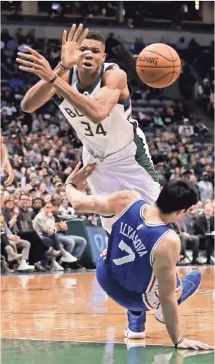  ?? ASSOCIATED PRESS ?? Giannis Antetokoun­mpo of the Bucks is fouled as he drives against the 76ers’ Ersan Ilyasova during the second half of Monday’s game in Milwaukee.