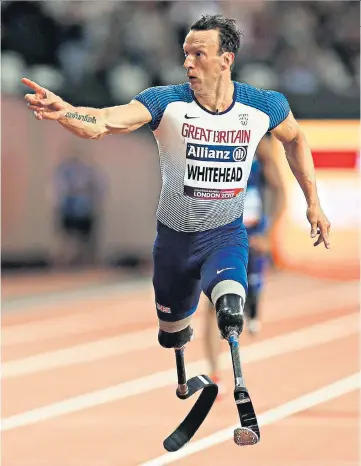  ??  ?? Proving his point: Richard Whitehead gestures to the fans as the Briton comes from behind to win the T42 200m last night