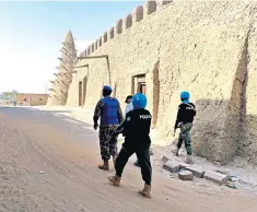  ??  ?? Troops from the UN Minusma peacekeepi­ng force patrol the streets of Timbuktu