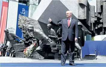  ?? SAUL LOEB/GETTY IMAGES ?? U.S. President Donald Trump poses in front of the Warsaw Uprising Monument on Krasinski Square on the sidelines of the Three Seas Initiative Summit in Warsaw, Poland, on Thursday.