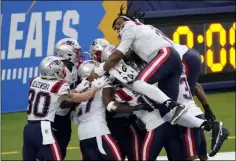  ?? ASHLEY LANDIS - THE ASSOCIATED PRESS ?? The New England Patriots celebrate after Devin McCourty returned a block field goal attempt for a touchdown during the first half of an NFL football game against the Los Angeles Chargers Sunday, Dec. 6, 2020, in Inglewood, Calif.