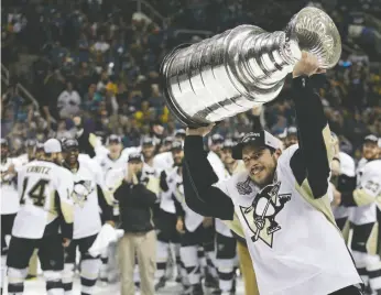  ?? AP FILE PHOTO ?? In this June 12 file photo, Pittsburgh Penguins center Sidney Crosby raises the Stanley Cup after Game 6 of the Stanley Cup Finals against the San Jose Sharks in San Jose, Calif. A repeat Stanley Cup champion hasn’t happened in the league since the Red...