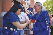  ?? ASSOCIATED PRESS ?? Marlene Poitras participat­es, Sunday, in a smudging, a ceremonial burning of scented plants for purificati­on and blessing, with church elder Fernie Marty outside of Sacred Heart Church of the First Peoples in Edmonton, Alberta.