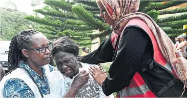  ?? SIMON MAINA AFP/GETTY IMAGES ?? A woman cries after identifyin­g the body of a relative at the Chiromo mortuary Wednesday in Nairobi, Kenya.