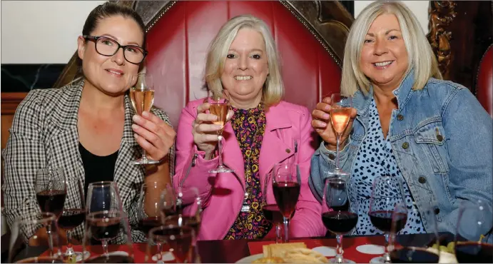  ?? ?? Caroline Nolan, Lorna Milligan and Gemma Maguire tuck into the cheese and wine tasting at Charlie’s, Enniskille­n.