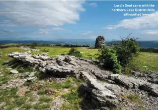  ??  ?? Lord's Seat cairn with the northern Lake District fells silhouette­d beyond.