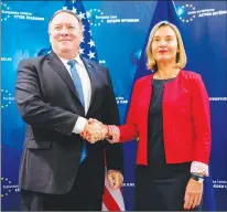  ?? AP PHOTO ?? Secretary of State Mike Pompeo and EU Commission Vice President Federica Mogherini pose for photograph­s as Pompeo arrives at the European Union European External Action Service in Brussels, Belgium, Thursday.