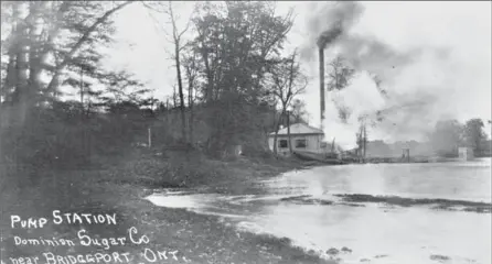  ?? RYCH MILLS COLLECTION ?? In a circa 1912 postcard, smoke pours from the pump house along the Grand River while a new concrete bridge pier rises from the river at right.