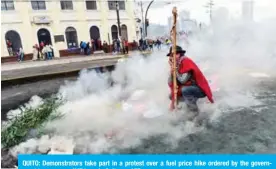  ?? AFP ?? QUITO: Demonstrat­ors take part in a protest over a fuel price hike ordered by the government to secure an IMF loan, in Quito. —