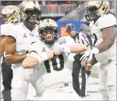  ?? Icon Sportswire via Getty Images ?? Central Florida quarterbac­k McKenzie Milton (10) celebrates a touchdown against Auburn during the Chick-fil-A Peach Bowl on January 1 at Mercedes-Benz stadium in Atlanta.