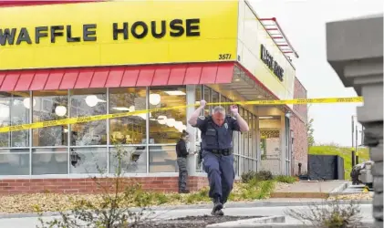  ?? THE ASSOCIATED PRESS ?? Law enforcemen­t officials work the scene Sunday of a fatal shooting at a Waffle House in the Antioch neighborho­od of Nashville.