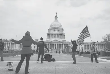  ?? ANNAMONEYM­AKER/THE NEWYORKTIM­ES ?? Supporters of President Donald Trump gather outside the U.S. Capitol on Monday.