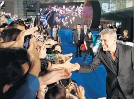  ?? Mi Ang
European Pressphoto Agency ?? CHINESE MOVIEGOERS spent $2.6 billion on tickets through May, according to Rentrak. Above, George Clooney at the Shanghai premiere of “Tomorrowla­nd.”