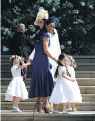  ?? JANE BARLOW / AFP / GETTY IMAGES ?? Canadian fashion stylist Jessica Mulroney (in blue) and Britain’s Catherine, Duchess of Cambridge, hold hands with bridesmaid­s before Saturday’s royal wedding.