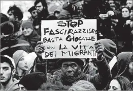  ?? TIZIANA FABI/GETTY-AFP ?? A protester holds a placard — “Stop the fascism and racism, stop playing with the migrants’ life” — during an anti-racism demonstrat­ion Saturday in Macerata, Italy.