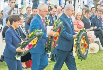  ??  ?? Turnbull (centre), Netanyahu (right), and Reddy (left) lay wreaths at the memorial for the fallen in the Battle of Beersheba during a ceremony marking the 100th anniversar­y of the battle held in the British Military Cemetery in Beersheba, Israel. — AFP photo