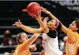  ?? Cassie Stricker / Associated Press ?? Texas A&M’s N’dea Jones shoots between Tennessee’s Marta Suarez, left, and Tamari Key.