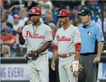  ??  ?? FRANK FRANKLIN III — THE ASSOCIATED PRESS Jose David Flores, right, next to Nick Williams, is more than just the Phillies’ first base coach. He’s also the baserunnin­g instructor and a big reasons the Phils are in playoff contention.