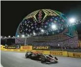  ?? NICK DIDLICK/AP ?? A Formula One driver races past a new high-tech venue in Las Vegas.