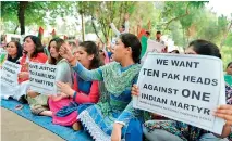  ??  ?? Indian activists from the National Panthers Party shout anti-Pakistan slogans and hold placards during a protest in Jammu against Pakistan. AFP