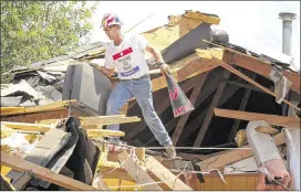 ?? JAY JANNER / AMERICAN-STATESMAN ?? Rusty Johnson helps at a home in West on June 11, 2013, following the explosion of a fertilizer plant. Though the blast killed 15 and destroyed buildings, lawmakers are not likely to impose stronger safety rules for Texas fertilizer facilities.