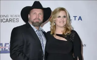  ?? Valerie Macon/AFP/Getty Images ?? Spouses and country music superstars Garth Brooks and Trisha Yearwood will host a holiday concert from their home on Sunday night, airing on CBS.