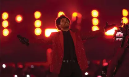  ?? Chart. Photograph: Chris O’Meara/AP ?? The Weeknd performs at the NFL Super Bowl in Tampa, Florida. Blinding Lights has been named the No 1 song on Billboard’s Greatest Songs of All Time Hot 100