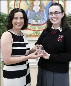  ??  ?? Principal Emma Raughter presents Katie Doyle with the award for Outstandin­g Attendance – perfect from 2011 to 2017.