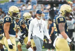  ?? ?? Navy coach Brian Newberry oversees warmups before Saturday’s season opener against Wagner.