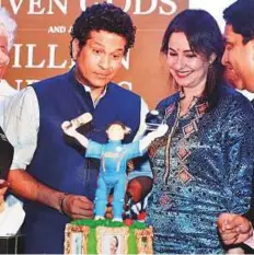  ?? PTI ?? Sachin Tendulkar cuts a birthday cake with his wife Anjali at a book launch function in Mumbai on Monday.