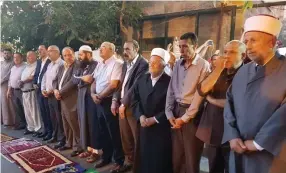  ??  ?? MKS AHMAD TIBI, Jamal Zahalka, Haneen Zoabi, Osama Saadi and Juma’a Azbaraga take part in evening prayers outside the Lions’ Gate to Jerusalem’s Old City yesterday.