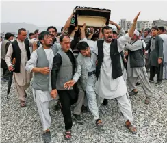  ??  ?? Conflict: The funeral of a suicide attack victim in Kabul