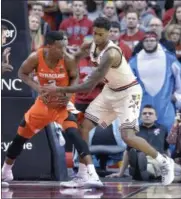  ?? PHOTOS BY TIMOTHY D. EASLEY — ASSOCIATED PRESS ?? Louisville’s Ray Spalding (13) attempts to strip the ball from Syracuse’s Andrew White III (3) during the first half of an NCAA college basketball game, Sunday, Feb. 26, 2017, in Louisville, Ky.