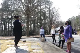  ?? MICHELLE LIU — THE ASSOCIATED PRESS ?? Marisa Davis, a graduate student at Clemson University, talks to a group touring Woodland Cemetery on campus in Clemson, S.C. on Sunday. Students and other university affiliates plan to hold regular tours about the cemetery’s history after hundreds of previously unmarked graves likely belonging to African Americans were identified last year.