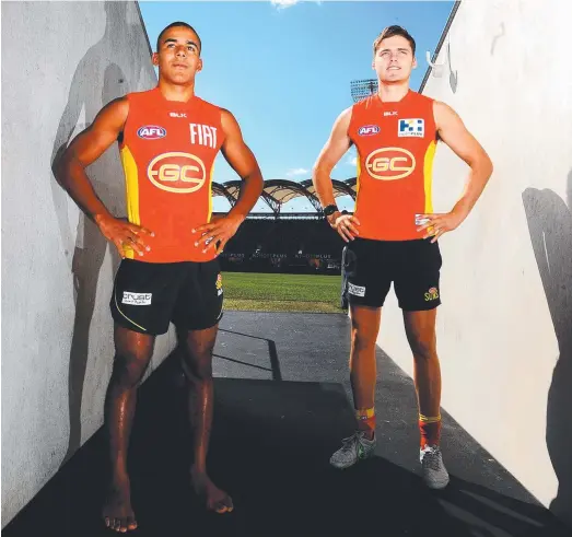  ?? Picture: JOHN GASS ?? TOP ATTENDANCE RECORD: Gold Coast Suns players Touk Miller (left) and Kade Kolodjashn­ij have not missed an AFL game this season.